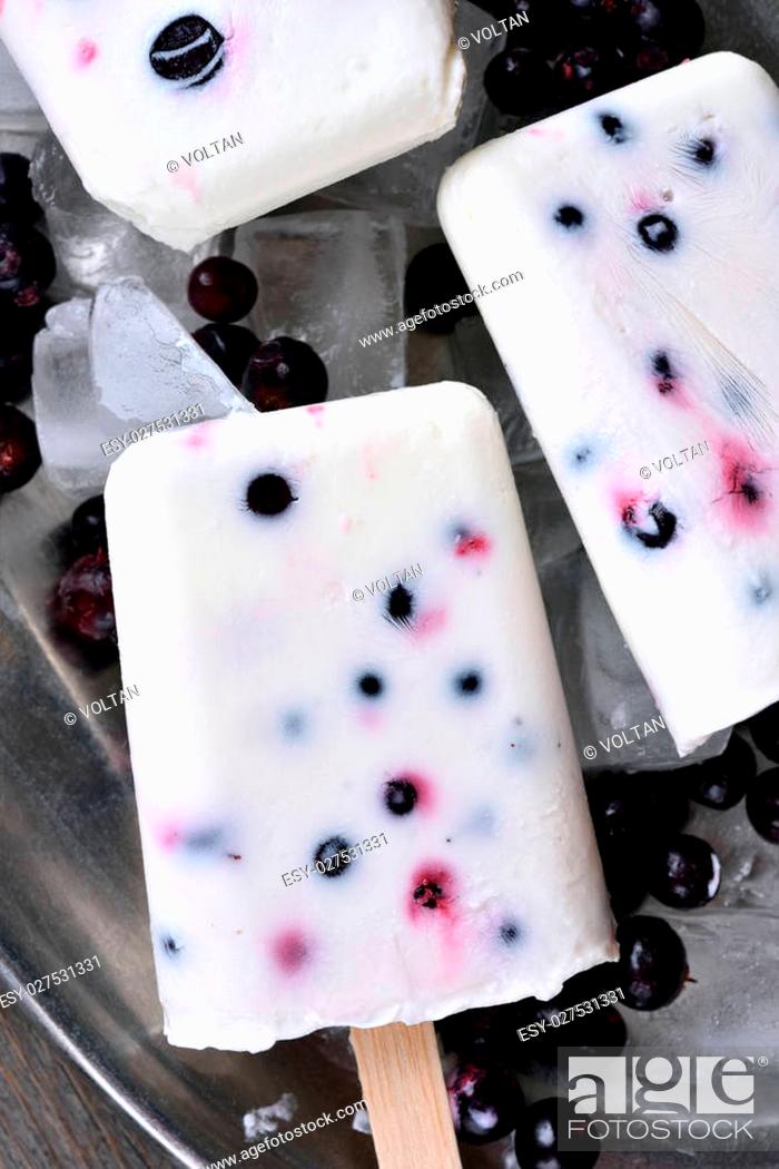 Stock Photo: Homemade popsicles from yogurt, blueberry and blackcurrant, close up view.