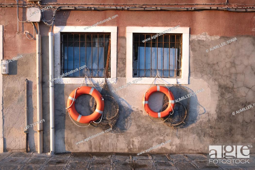Stock Photo: View of lifebuoys and fishing nets on the window in Venice, Veneto, Italy, Europe.
