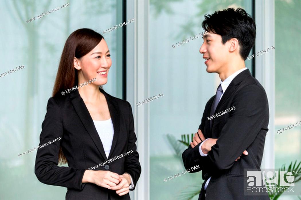 Stock Photo: Businesswoman and businessman discuss together.