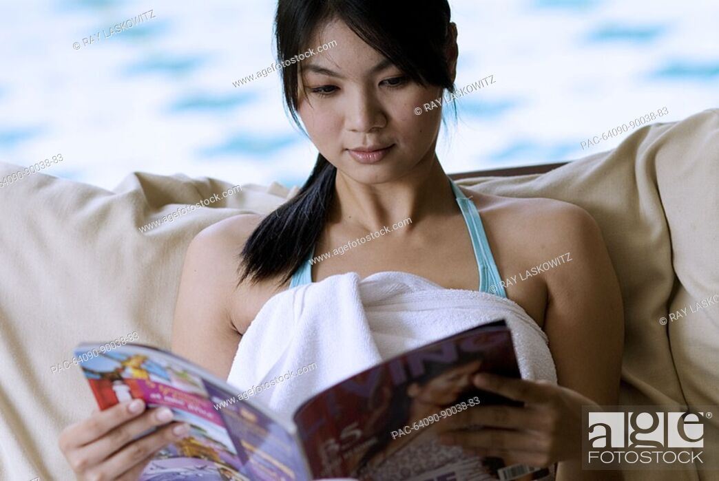 Stock Photo: Thailand, Bangkok, Thai woman relaxing in spa like setting.