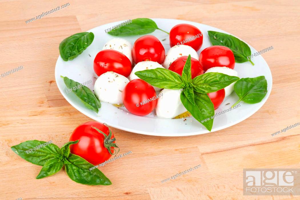 Stock Photo: Caprese salad plate on wooden table.