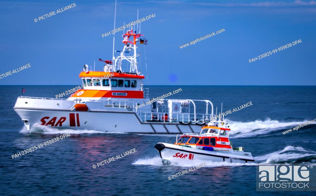 Stock Photo: PRODUCTION - 27 July 2023, Mecklenburg-Western Pomerania, Zingst: The 28-meter-long and nearly 4, 000-hp marine rescue cruiser ""Nis Randers"" sails with its.