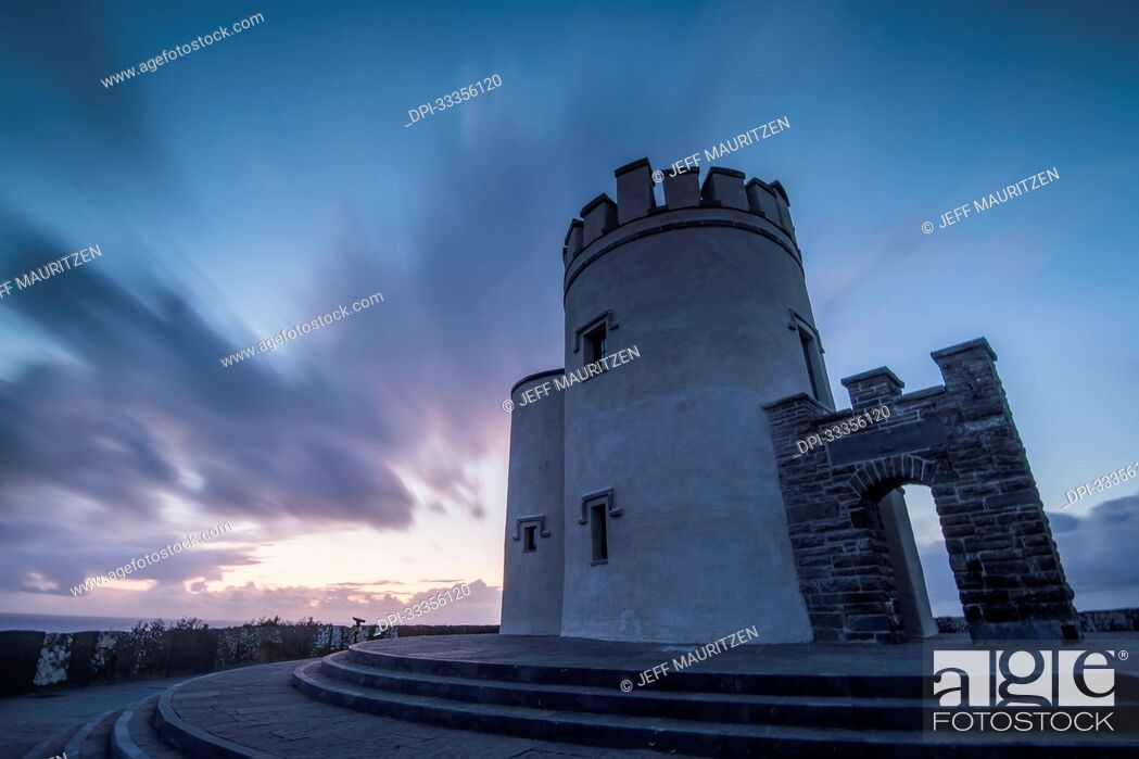 Stock Photo: O'Brien's Tower with a dramatic sky at dusk overlooking the ocean along the Cliffs of Moher on the Atlantic Coast; County Clare, Ireland.