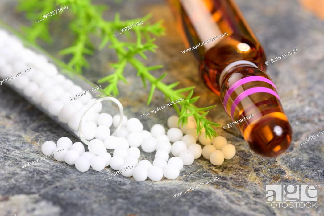 Stock Photo: alternative medicine with herbal and homeopathic pills with essence from medicinal plant.