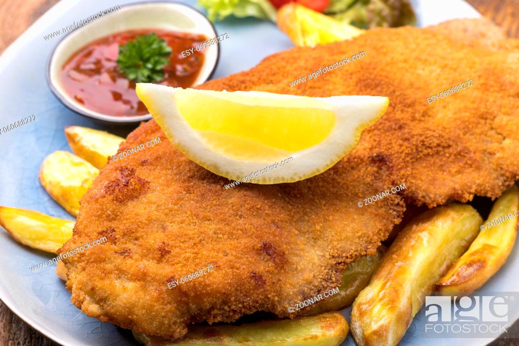 Stock Photo: wiener schnitzel with fries on a plate.