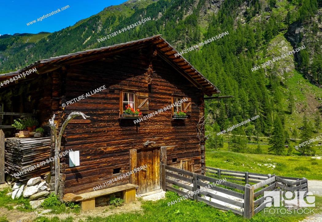 Stock Photo: 22 July 2021, Austria, Sankt Jakob: The Patscher Valley with the Patscher Hut in the Defereggen Valley in Tyrol. The Defereggen valley lies in the middle of the.