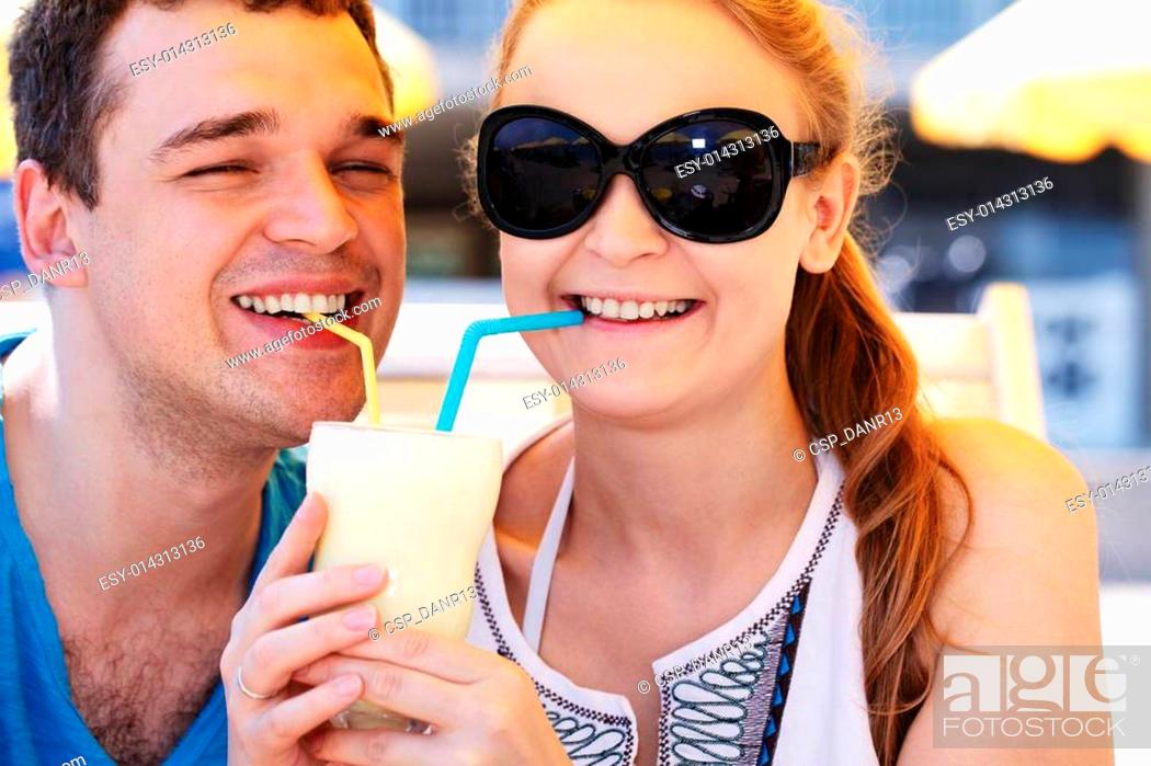Stock Photo: Romantic couple sharing a cocktail.