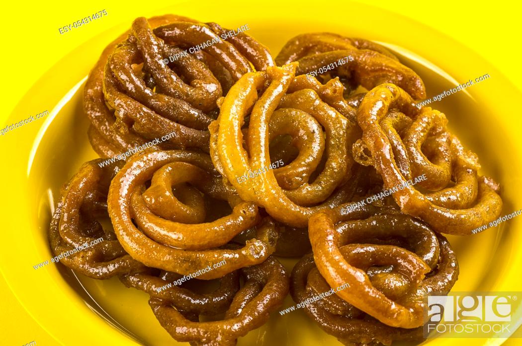 Stock Photo: Indian sweet jalebi, indian dessert jalebi or imarti or imarati or jilbi on yellow background.