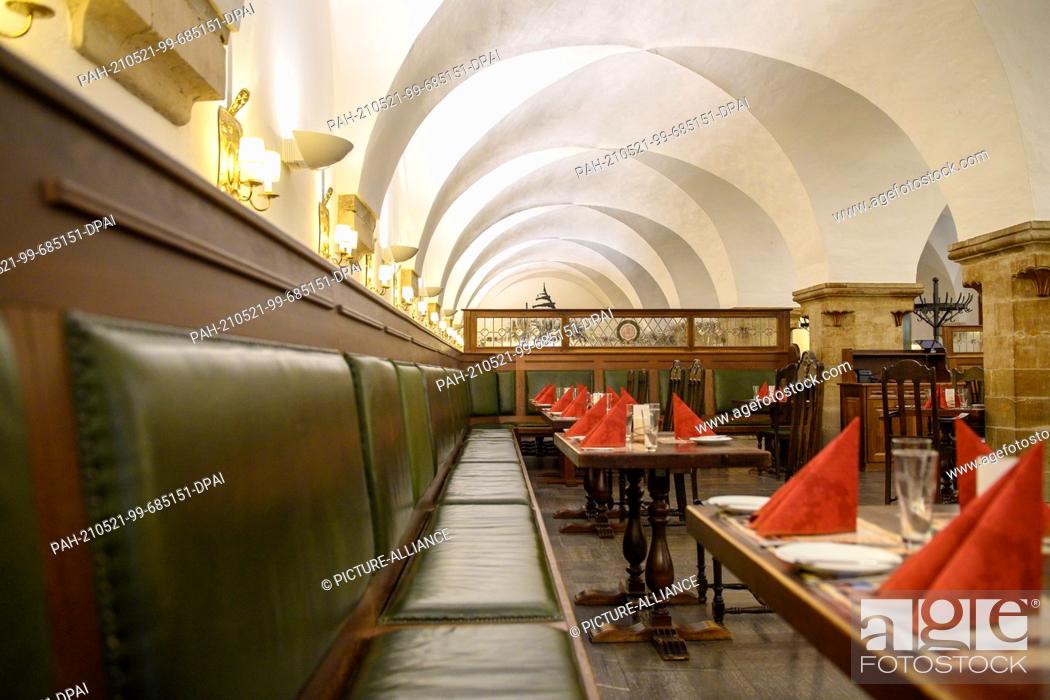 Stock Photo: 20 May 2021, Saxony-Anhalt, Magdeburg: Empty but already set tables in the historic restaurant ""Ratskeller"". Where the federal emergency brake no longer.
