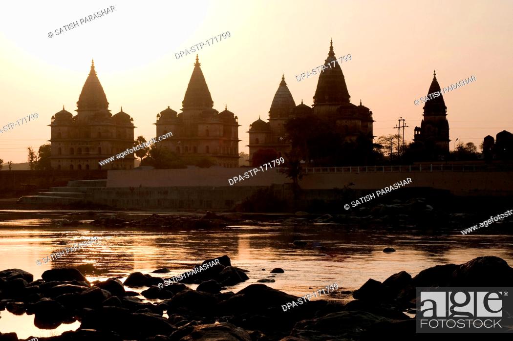 Stock Photo: Sunset with cenotaphs at bank of river Betwa , Orchha , Tikamgarh , Madhya Pradesh , India.