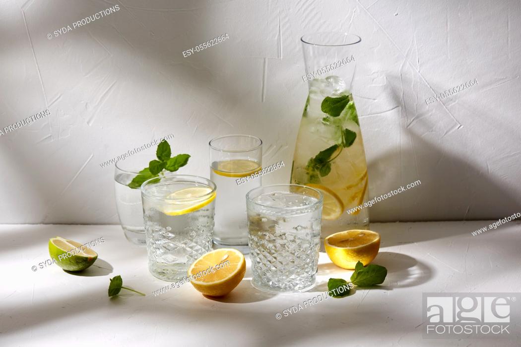 Stock Photo: glasses with lemon water and peppermint on table.