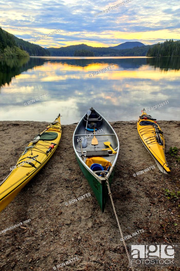 Stock Photo: Kayaks and a canoe rest on the shore of Main Lake, in Main Lake Provincial Park on Quadra Island, British Columbia, Canada.
