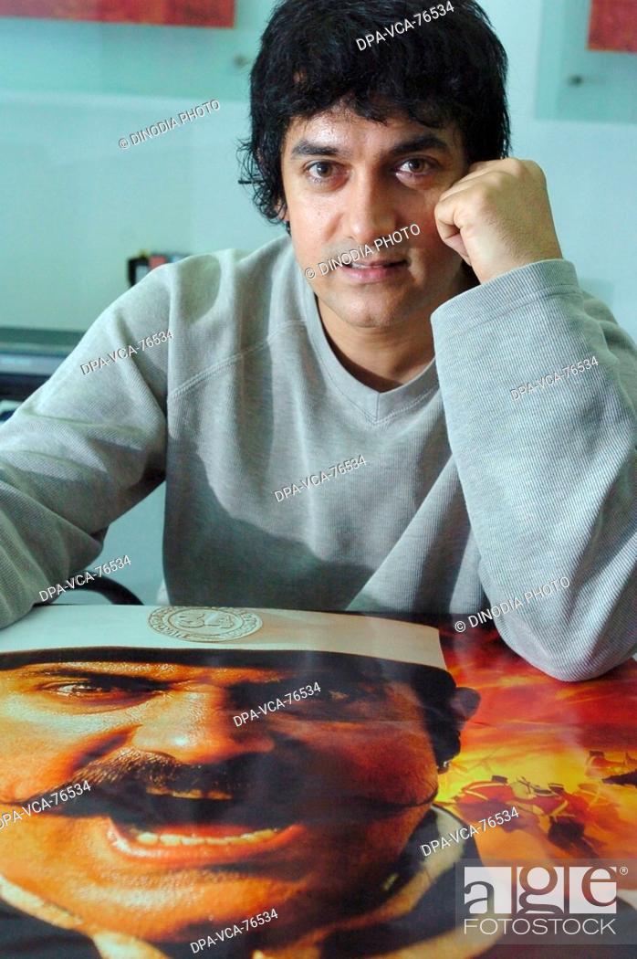 Stock Photo: South Asian Indian Bollywood Film actor Aamir Khan with a  poster of his film Mangal Paandey; Mumbai bombay; Maharashtra; India NO MODEL RELEASED.
