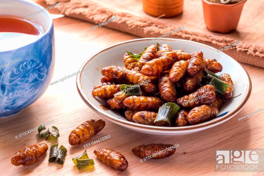 Stock Photo: Fried insects - Wood worm insect crispy with pandan after fried and add a light coating of sauce and garnish Thai pepper powder, tea.