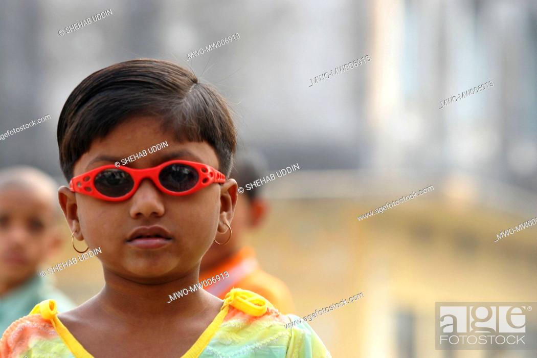 Stock Photo: Portrait of a rural child wearing toy sunglass at a fair during Eid-ul-Adha festival Eid-ul-Adha is one of the two main Muslim religious festivals the other one.