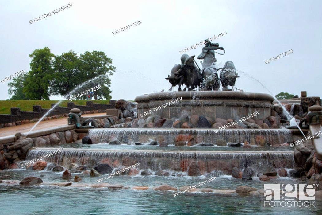Stock Photo: Gefion Fountain, Copenhagen, Denmark. Statue of man riding bulls by a fountain in the city of Copenhagen, Denmark. Gefion fountain is the largest fountain in.