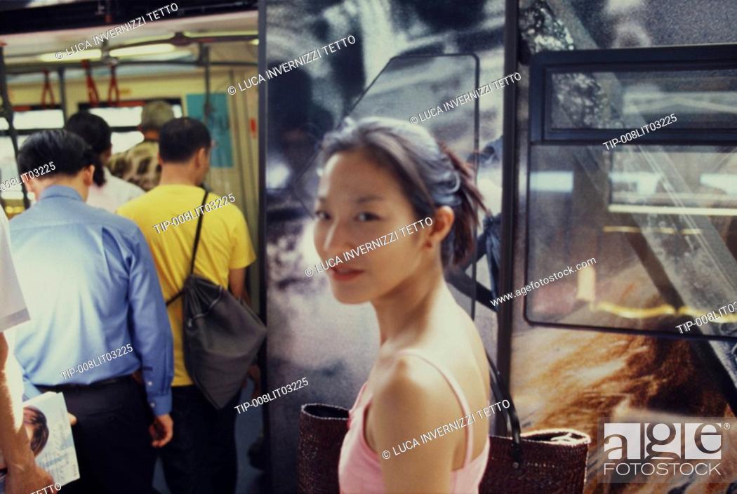 Stock Photo: thai girl on the skytrain, Bangkok, Thailand.