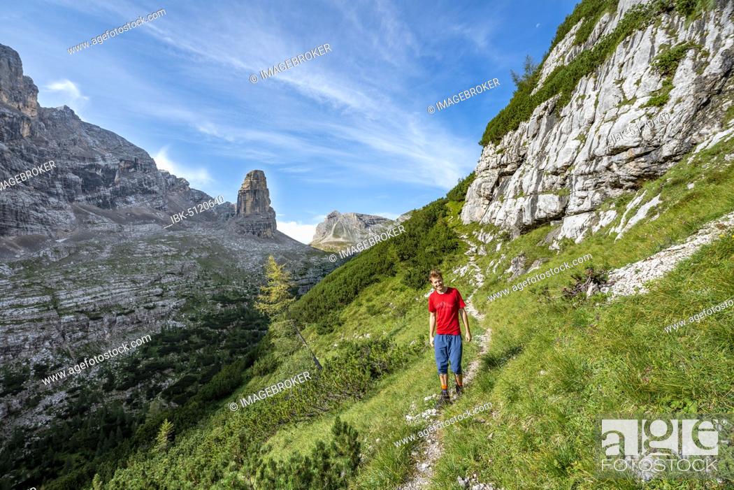 Stock Photo: Young hiker on the Sentiero Carlo Minazio path, at the back of the Torre dei Sabbioni, Sorapiss circuit, Dolomites, Belluno, Italy, Europe.