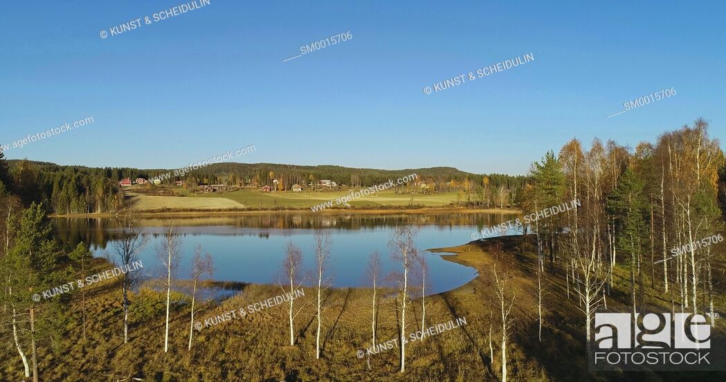 Stock Photo: Aerial shot of a glassy lake with farm houses on a sunny autumn day. Skalmsjö, Bredbyn, Västernorrland, Sweden, Europe.