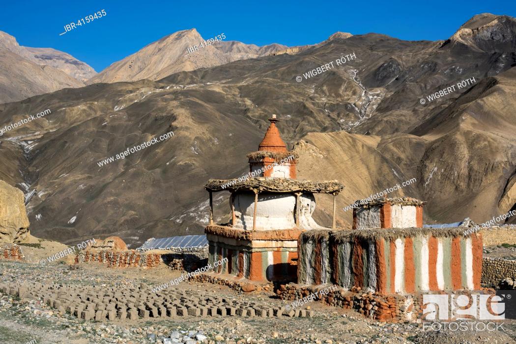 Stock Photo: Buddhist stupas in front of mountain landscape, prayer or reliquary shrine, dried mud or adobe bricks on the ground, Tangge, former Kingdom of Mustang, Nepal.