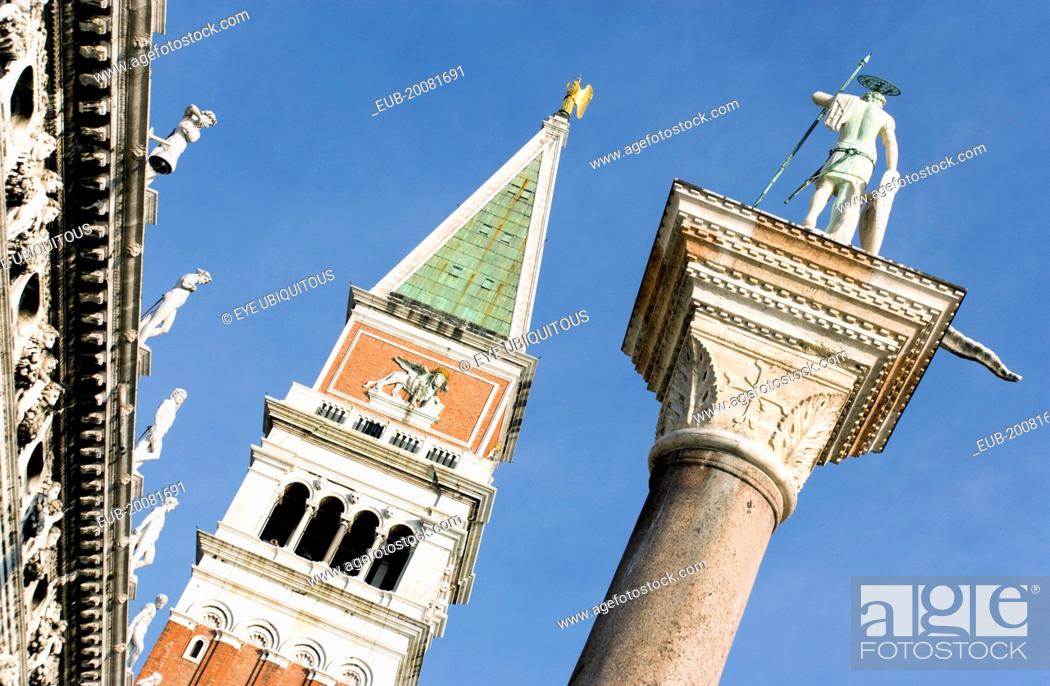 Stock Photo: The Campanile in St Mark's Square with the Column of San Teodoro, the original patron saint of Venice, on the right.