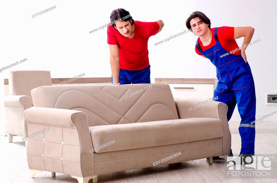 Stock Photo: Two young contractor employees moving personal belongings.