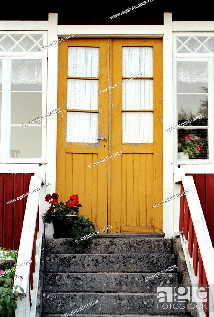 Stock Photo: A red house with a ellow door, Smaland, Sweden.
