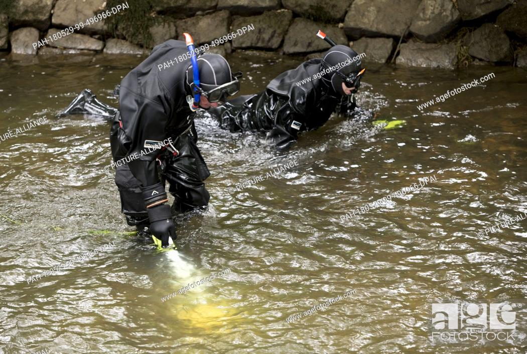 Stock Photo: 29 May 2018, Germany, Offenburg: Task forces of the water police searching the Muehlbach river near the university of applied sciences in Offenburg as part of.