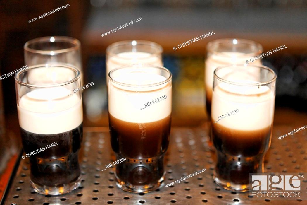 Stock Photo: Six half poured Guiness in the pub the Quais, Galway, Galway, Ireland.