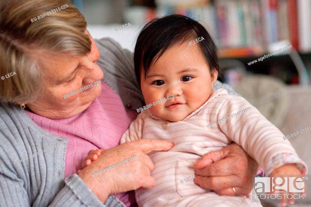 Stock Photo: 7-month old baby with her adoptive grandmother.