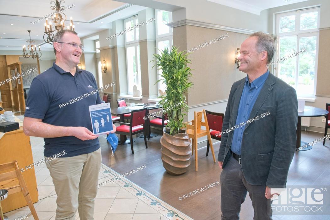 Stock Photo: 10 June 2020, Mecklenburg-Western Pomerania, Heringsdorf: Peter Maier, hotel director of the Upstalsboom Hotel Ostseestrand (l), talks to Tilman Jeremias.