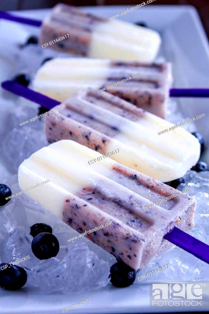 Stock Photo: Homemade Vanilla, Blueberry and Coconut Milk Popsicles.