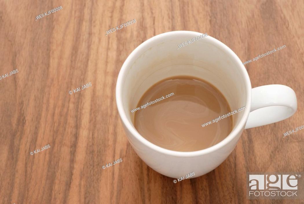 Stock Photo: Cup of coffee on wooden table, elevated view.