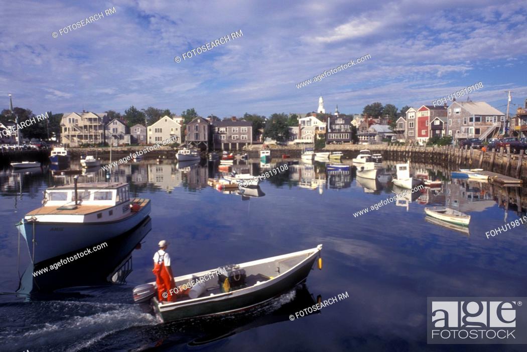 Stock Photo: Rockport, Massachusetts, Atlantic Ocean, Boats (fishing, lobster) in the harbor of a scenic fishing village. A fisherman chugs along in his dinghy.