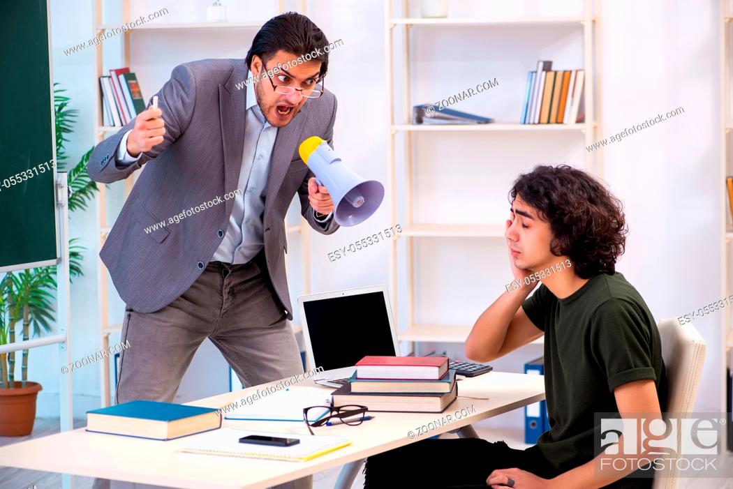 Stock Photo: Young teacher and student in the classroom.