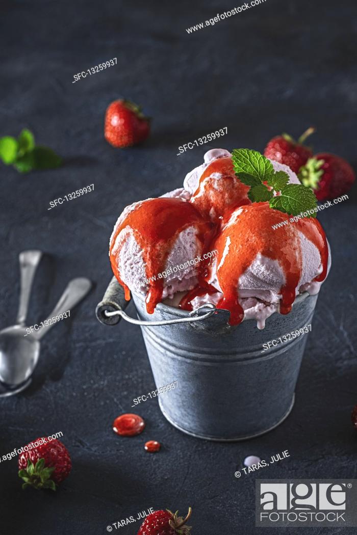 Stock Photo: Strawberry ice cream with sauce and mint.