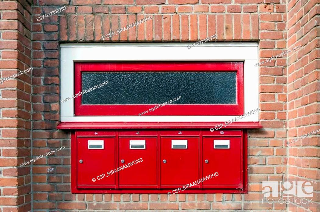 Stock Photo: Mailbox and window outside apartment building.