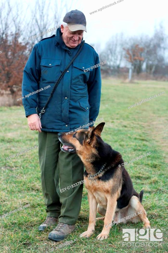 Stock Photo: Smart German Shepherd dog/Alsatian and his master.