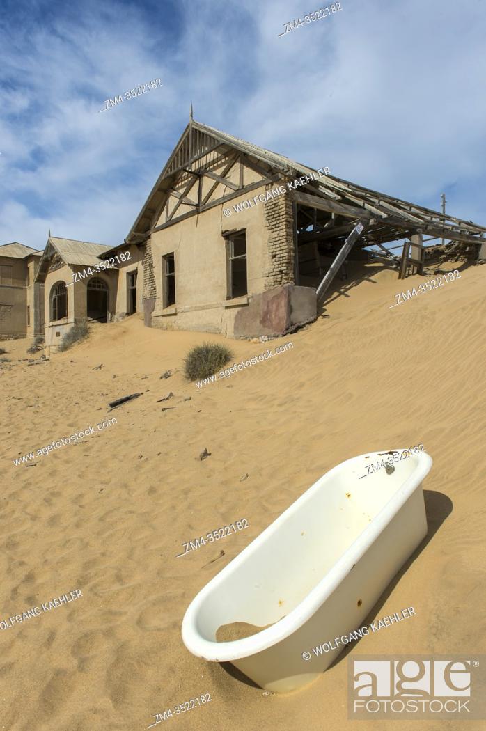 Stock Photo: Bathtub in the sand in front of a building in the abandoned (1954) German diamond mining settlement of Kolmanskop near Luderitz, Namibia.