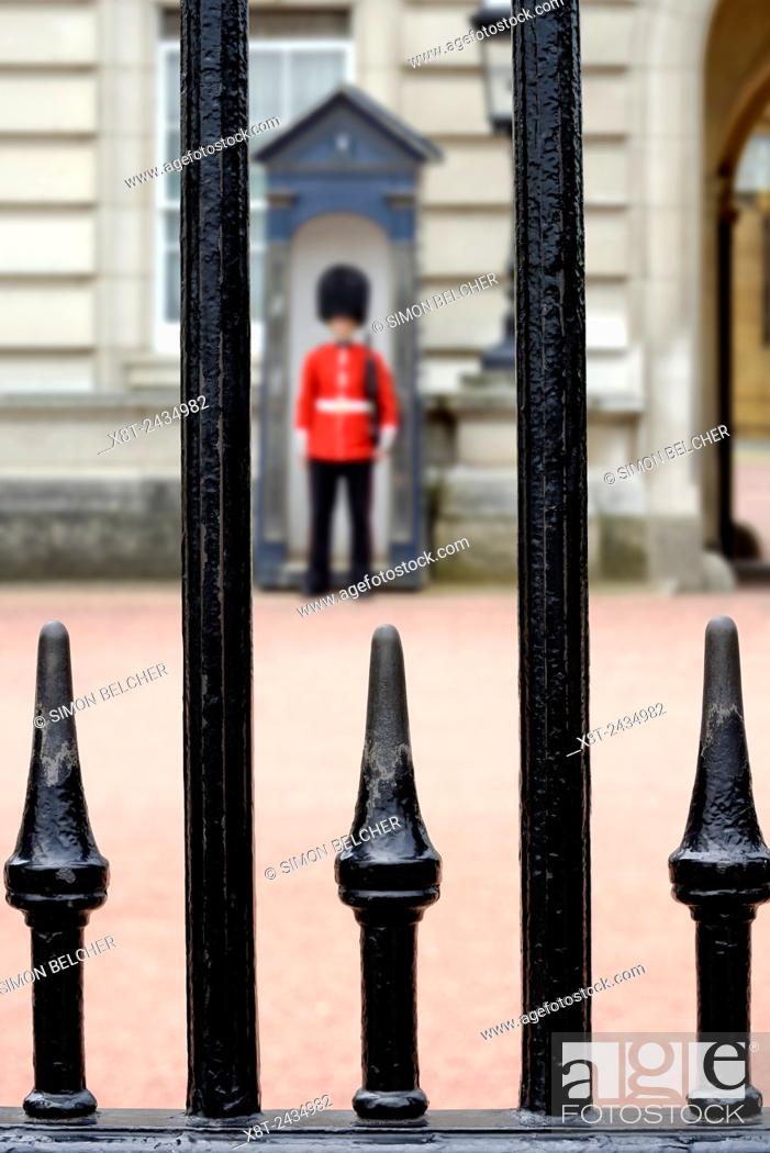 Stock Photo: Guardsman Outside Buckingham Palace, Viewed Through the Railings. London, England, United Kingdom.