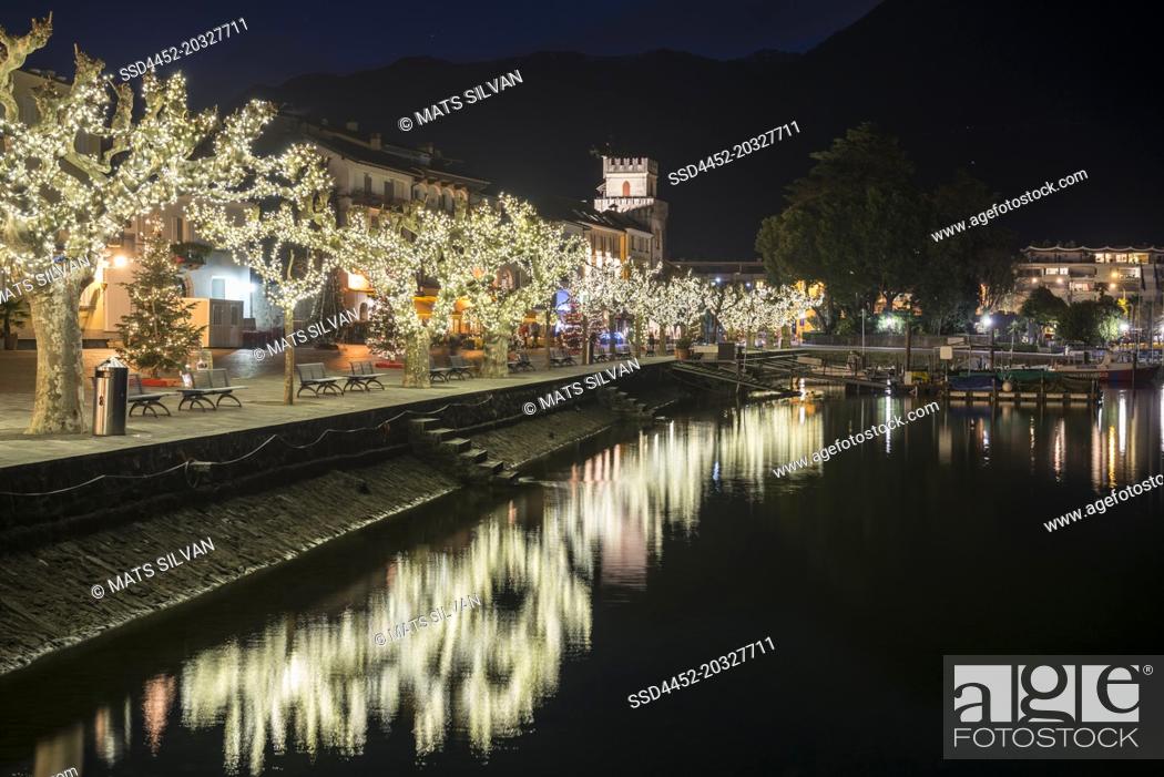 Stock Photo: Waterfront with Illuminated Bare Tree on Alpine lake Maggiore at Night in Ascona, Switzerland.