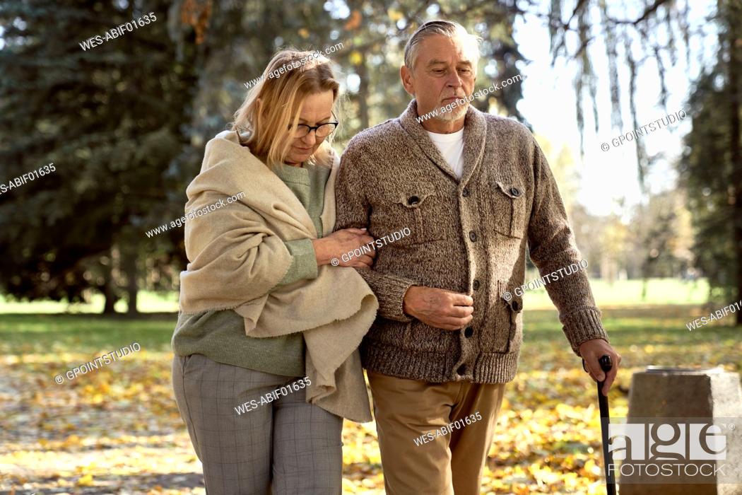 Stock Photo: Senior couple walking at public park.