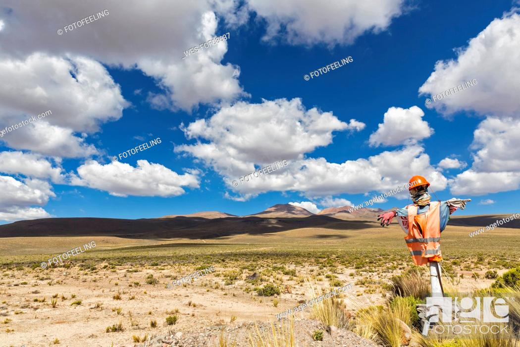 Stock Photo: Peru, La Reserva Nacional Salinas y Aguada Blanca, humanlike figure at the roadside in front of volcanic landscape.