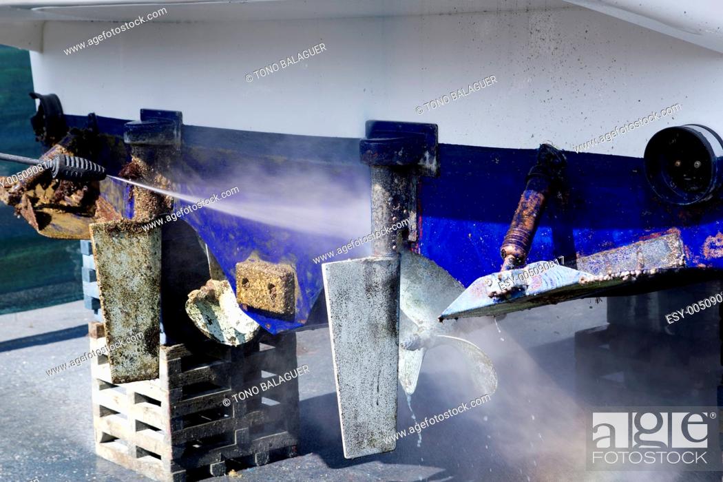 Stock Photo: blue boat hull cleaning pressure washer barnacles.