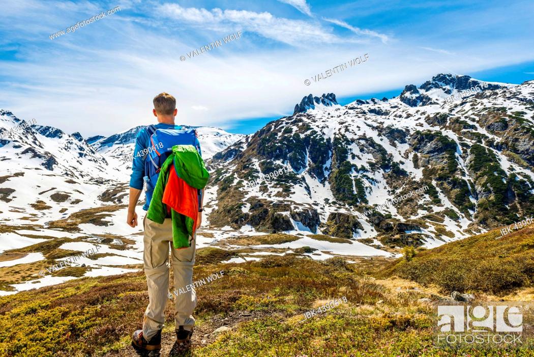 Stock Photo: Young man hiker looks into the distance, mountain landscape, snow melts, Rohrmoos-Untertal, Schladming Tauern, Schladming, Styria, Austria.