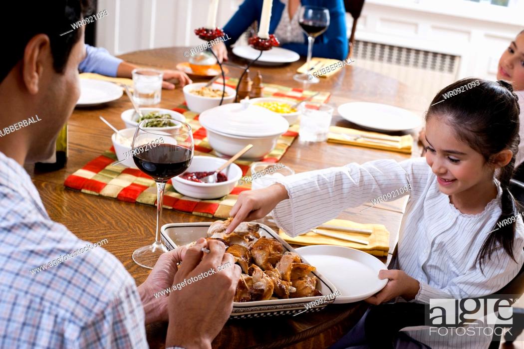 Stock Photo: Family sitting at dinner table.