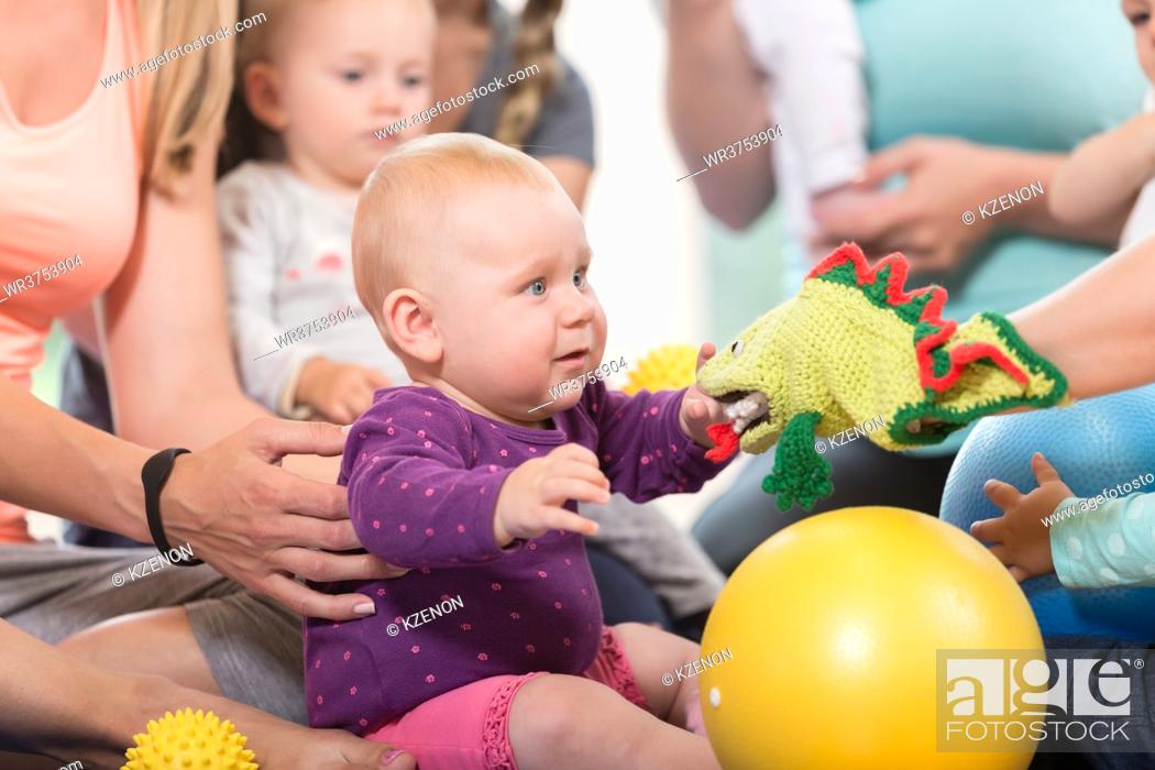 Stock Photo: Young women in mother and child group playing with their baby kids.