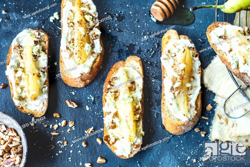 Stock Photo: Bruschetta with cream cheese and pear, nuts and honey.