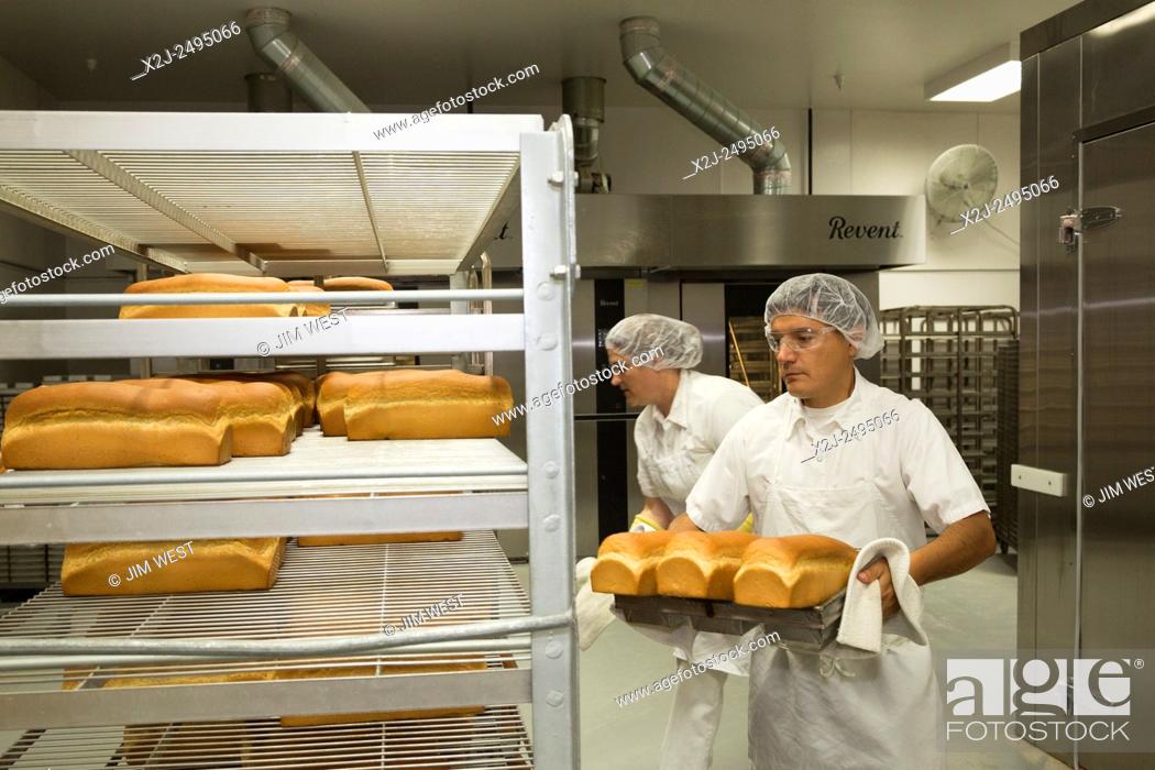 Stock Photo: Salt Lake City, Utah - Workers put fresh-baked bread on cooling racks in the bakery at the Mormon Church's Welfare Square complex.