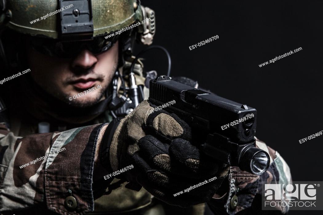 Imagen: United states Marine Corps special operations command Marsoc raider with pistol. Studio shot of Marine Special Operator black background.